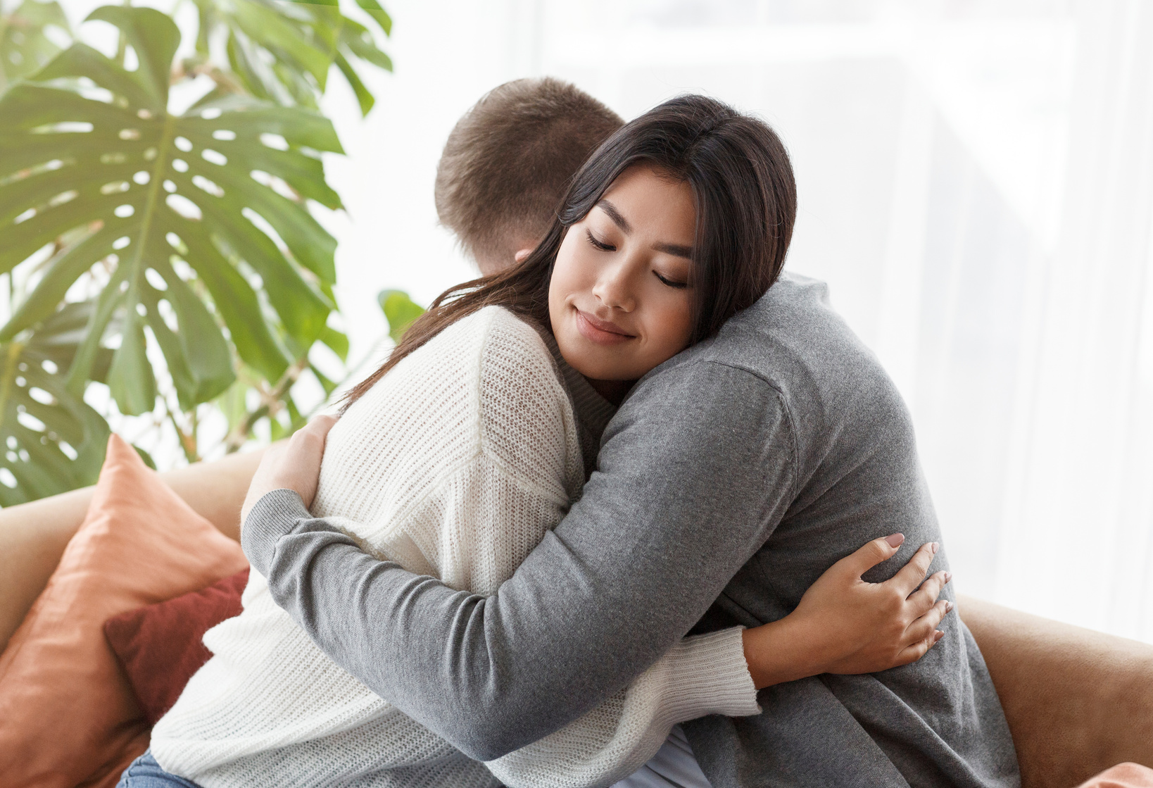 Loving Spouses Hugging After Couple Therapy Sitting In Psychologist's Office